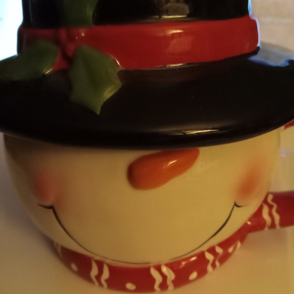 S woman large bot cocoa mug with large black hat as cover